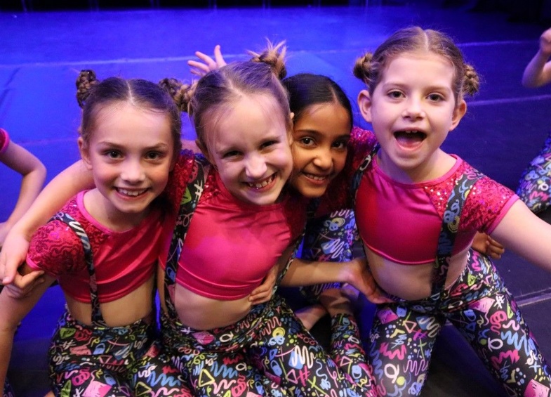 Four girls look happy as they prepare to go on stage for the Heath Mount Dance Show